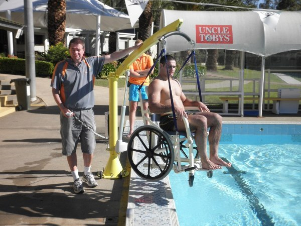 Man using pelican pool hoist